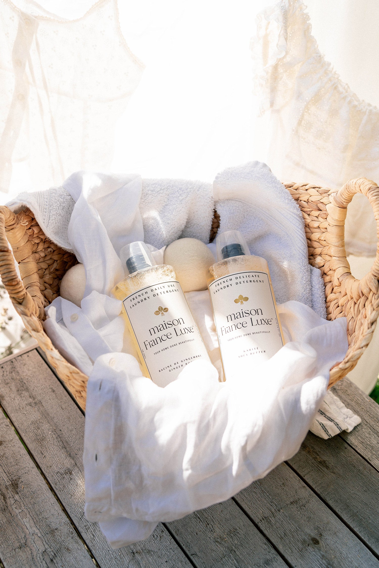 Luxury Laundry Detergent for everyday use and delicate fabrics, in a basket with white linens.